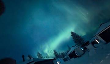 Aurora Borealis over a snowy landscape.