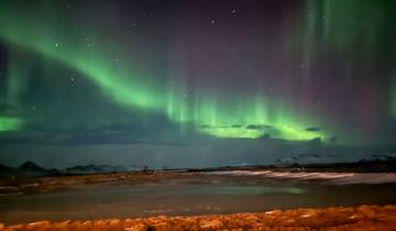 The aurora borealis over a snowy landscape.