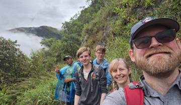 Hikers on a mountain trail with scenic view.