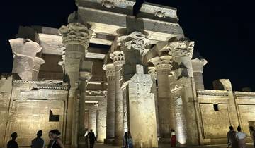 An ancient Egyptian temple illuminated at night.