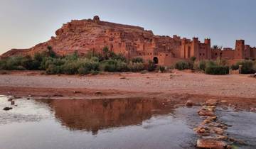 Ait Benhaddou with its ancient earthen buildings reflecting in a creek.