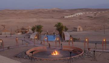 Desert landscape with a campfire and pool.