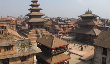Panoramic view of a historic city square with ancient pagodas.
