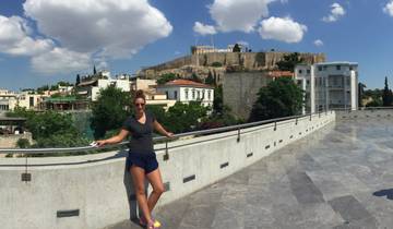 Woman posing in front of the Acropolis in Greece.