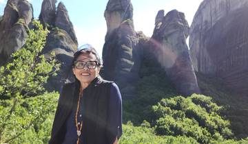 Woman posing with dramatic rock formations.