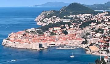 Aerial view of Dubrovnik with its distinct orange rooftops and forts by the sea.