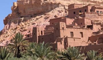 Traditional adobe buildings against a mountain backdrop.