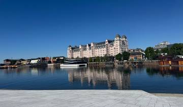 Waterfront view with buildings and reflections on a clear day.