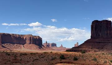 Vast desert landscape with monumental rock formations.