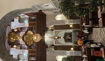Intricate interior of a Moroccan restaurant with diners.