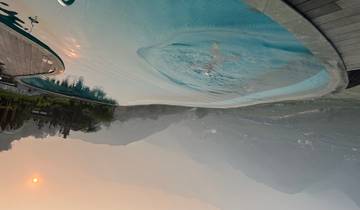 Infinity pool overlooking a misty valley at sunset.