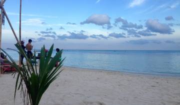 Scenic beach with people relaxing and enjoying the view.