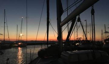 Yachts at a marina during sunset.