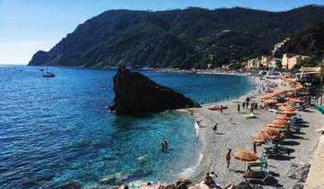 Scenic beach with umbrellas and clear blue water.