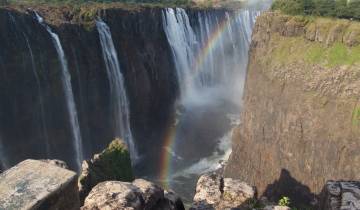 The majestic Victoria Falls with a brilliant rainbow.