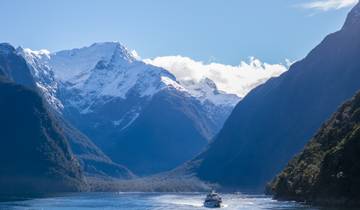 Snow-capped mountains with a body of water below.