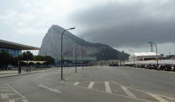 Rock of Gibraltar towering over an empty parking lot.