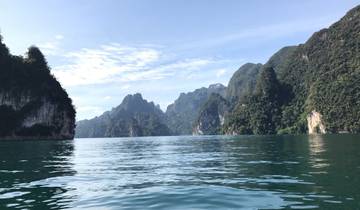 Beautiful blue water surrounded by tall mountains.