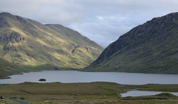 Mountainous landscape with a lake in the foreground.