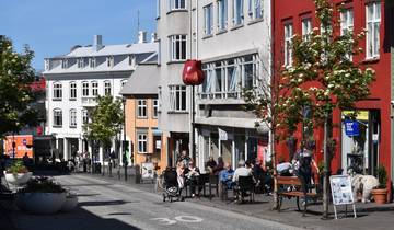 Street scene with colorful buildings and outdoor diners.