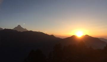 Sunset over the mountains in Nepal with a clear sky.