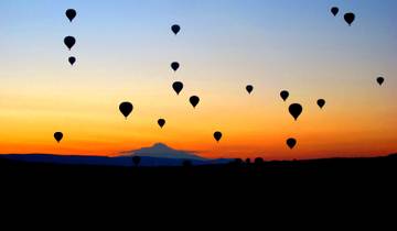 Hot air balloons at sunset over Cappadocia.