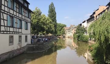 Quaint canal running through a town with timber-framed houses.