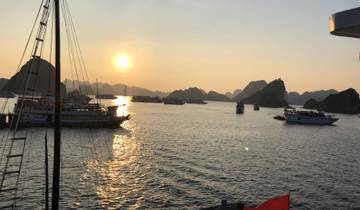 Sunset view over a bay filled with boats.