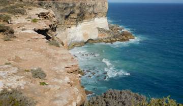 Ocean waves hitting rocky cliffs.