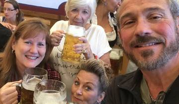 Group of people enjoying large mugs of beer indoors.
