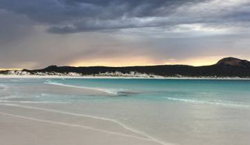 A beautiful coastal view with turquoise water and sandy beach.