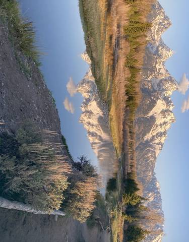 Majestic mountain range reflecting in calm waters.