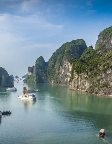 Spectacular view of limestone karsts and boats in Halong Bay.