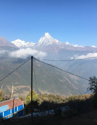 Majestic mountain scenery with rooftops in the foreground.