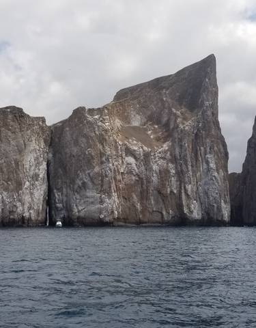 Dramatic rock formations rising from the ocean.