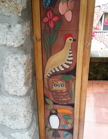 Scenic landscape with a lake, open fields, and mountains in the background.