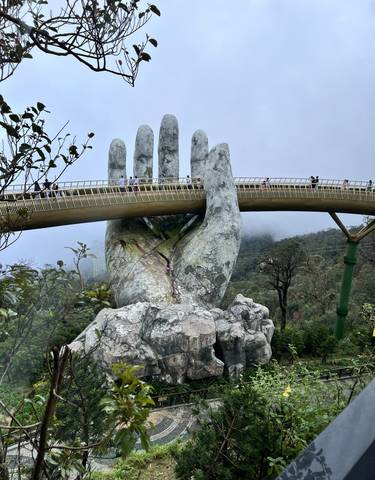 Golden Bridge with giant hand sculpture