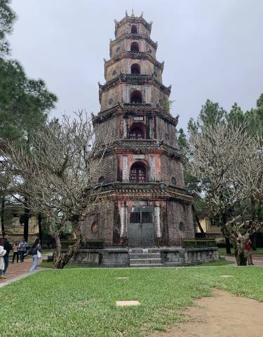 Historic pagoda surrounded by leafless trees.