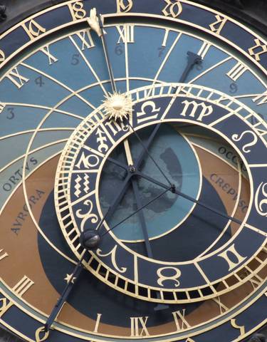 Close-up of an astronomical clock face with intricate design.