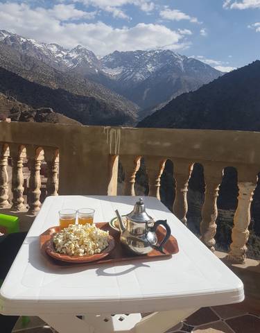 Mountain view from a terrace with tea set and snacks