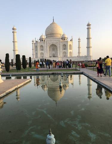 Taj Mahal with reflecting pool and visitors