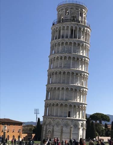 The Leaning Tower of Pisa under a blue sky.