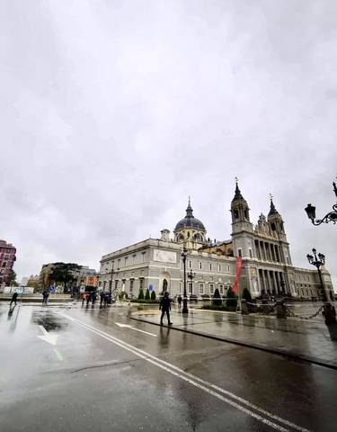 A grand cathedral with intricate architectural details in a public square.