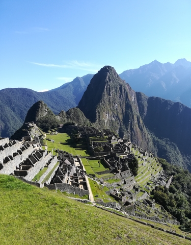 Panoramic view of Machu Picchu with mountains in the background.