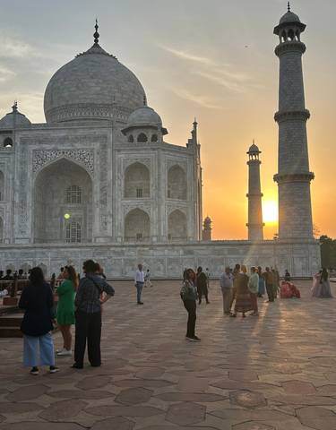Visitors at the Taj Mahal during sunset.