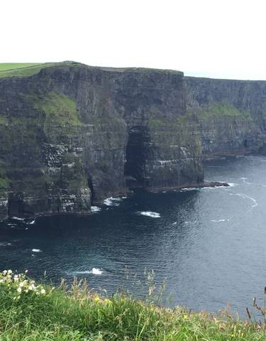 Dramatic cliff face with a deep cove and ocean below.
