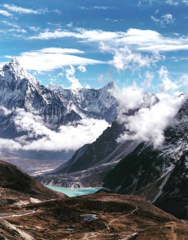 Mountain range with clouds in the valleys below.