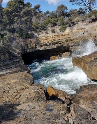 Rocky coastal scenery with a waterfall.