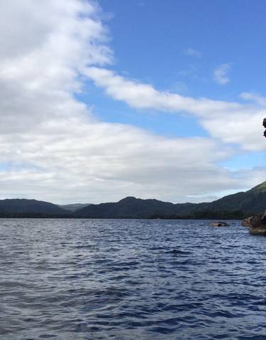 Scenic lake with mountainous background.