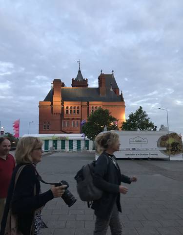 Historic building with people walking in the foreground.